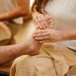 Close-up of a foot massage in a spa setting, highlighting relaxation and wellness.