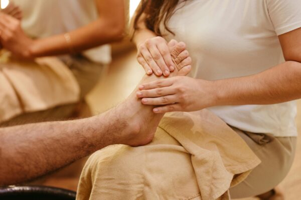 Close-up of a foot massage in a spa setting, highlighting relaxation and wellness.
